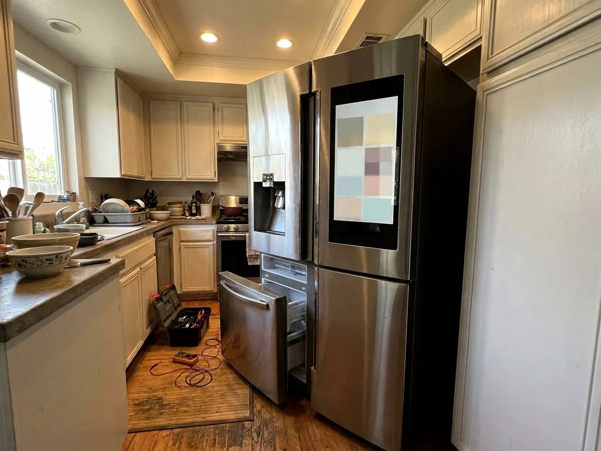 Four-door French door refrigerator with a large touchscreen on the right door