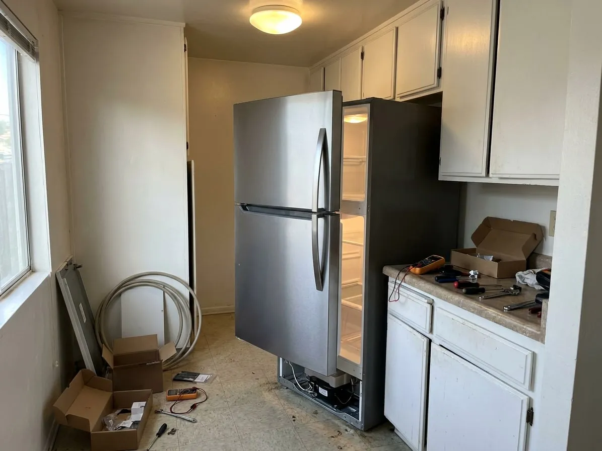 Stainless top-freezer refrigerator in an apartment kitchen